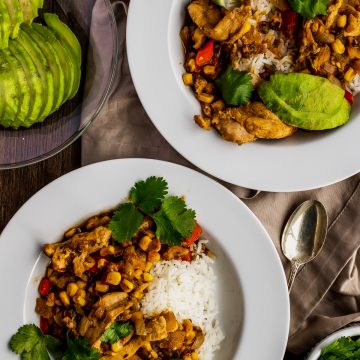 two bowls of salsa verde with avocado and cilantro