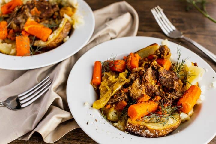 two bowls of mississippi pot roast served with baked potatoes