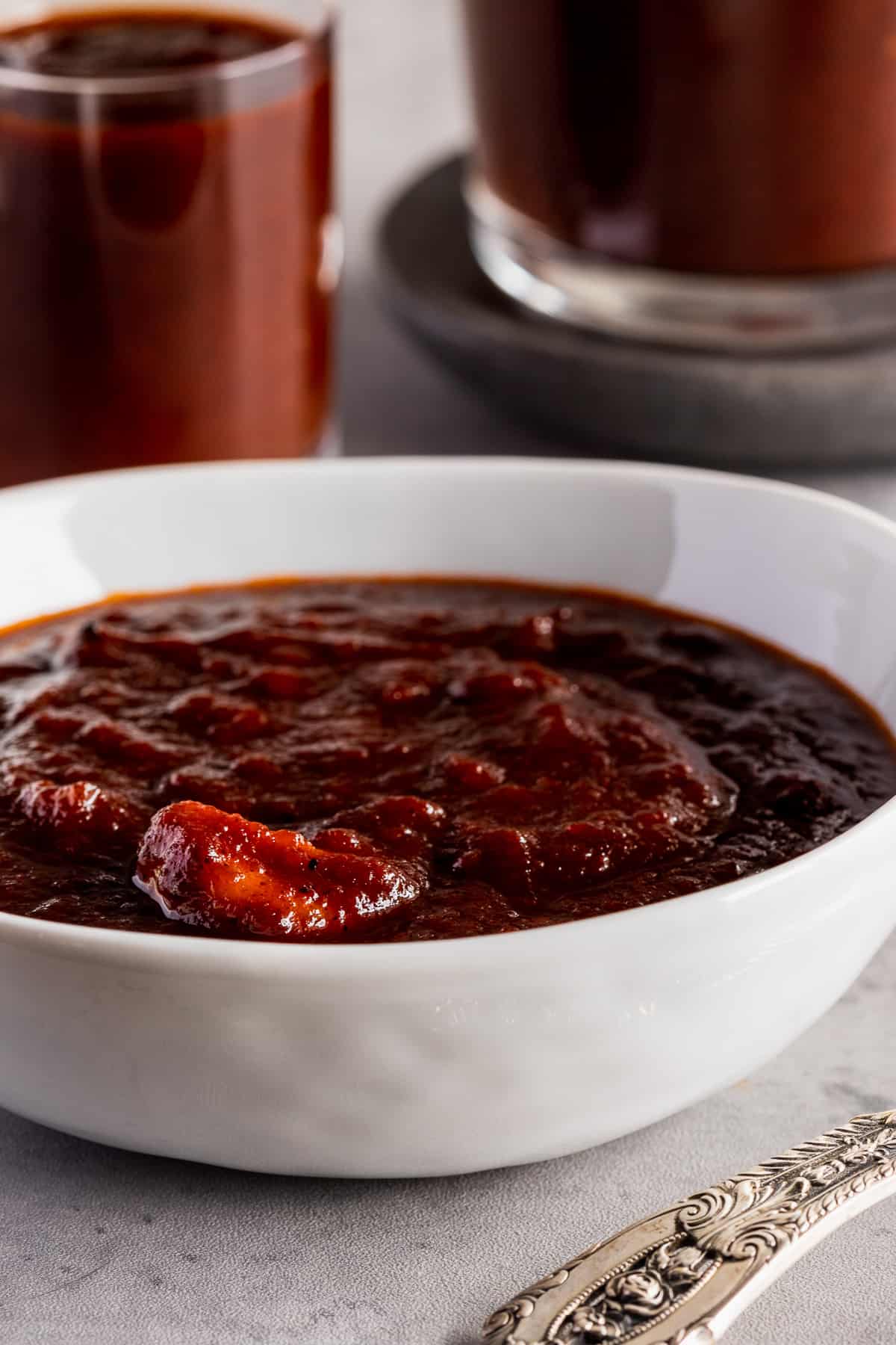 bowl of bbq sauce with clove of garlic visible