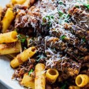 close up platter of rigatoni and sliced meat