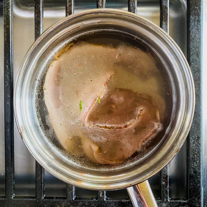 a pot of water boiling with bacon