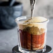 jar of seasoning mix with a mortar and pestle in the background